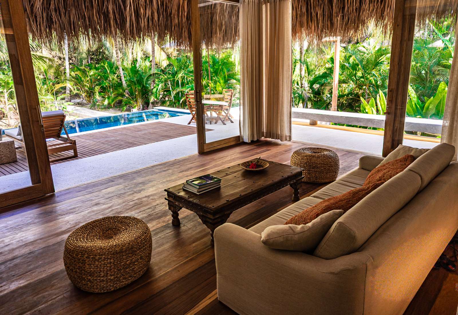 Villa lounge opening onto its pool